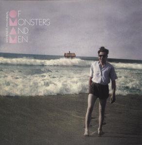 The image shows the album cover for 'Of Monsters & Men - My Head' featuring a man standing on a beach with a monstrous wave in the background, with the band's name and album title above.
