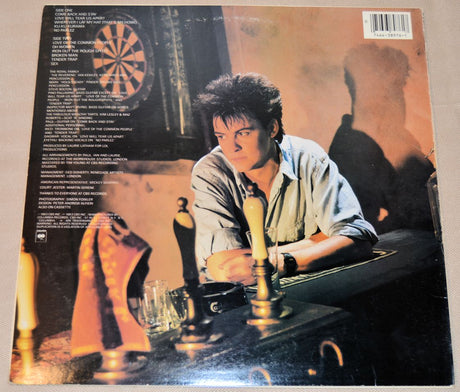 Paul Young 'No Parlez' vinyl record back cover showing Paul sitting in a pub with a dartboard on the wall.