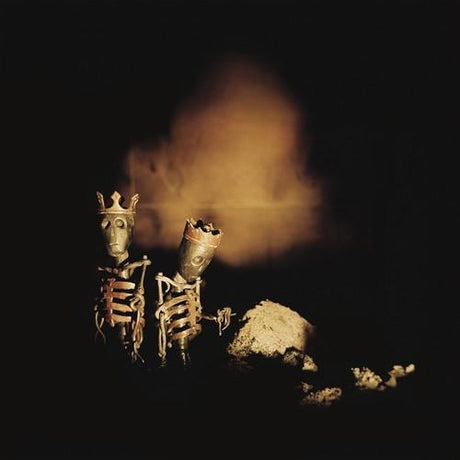 Two small skeletons with crowns on a dark background