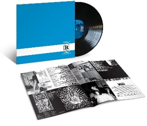 A vinyl record of Queens Of The Stone Age - Rated R with the album artwork laid out next to it.