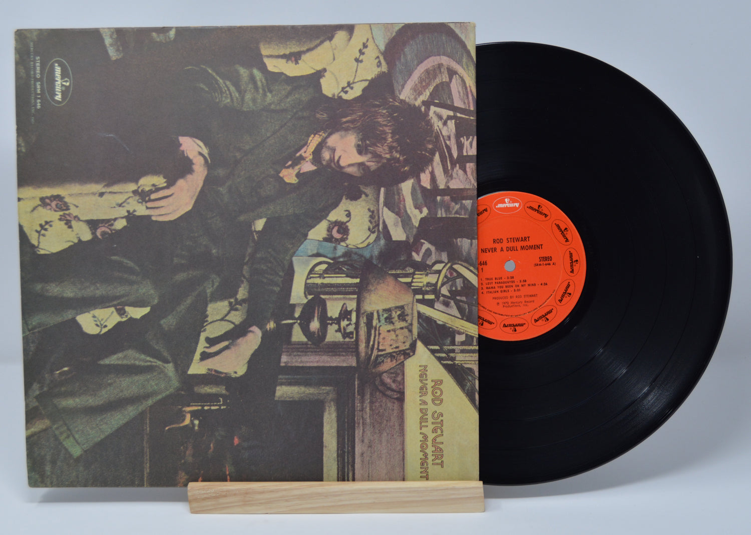 Vinyl record with cover featuring a person and text on a light gray background