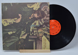 Vinyl record with cover featuring a person and text on a light gray background
