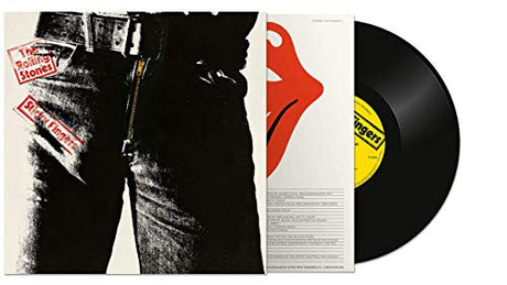 'Sticky Fingers' by the Rolling Stones showing the vinyl record and front cover with the Andy Warhol design of a man's waist and upper legs in black jeans and belt.