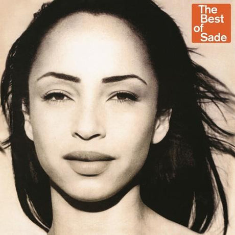 This image features the cover art for the vinyl record "Sade - Best Of," a greatest hits album by the British band Sade. The album cover displays a close-up, black and white photograph of Sade Adu, the lead vocalist, capturing a serene yet captivating expression.