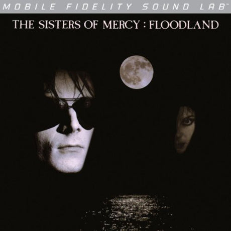 Album cover for 'Floodland' by The Sisters of Mercy with two faces and a moon in the background.