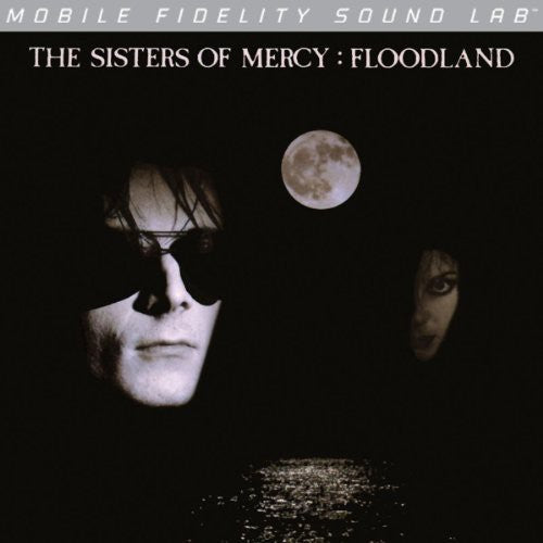 Album cover for 'Floodland' by The Sisters of Mercy with two faces and a moon in the background.