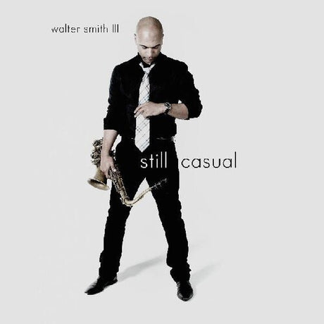 A vinyl record cover featuring a black and white image of a man with a saxophone, along with the title 'Still Casual' by Walter Smith III.