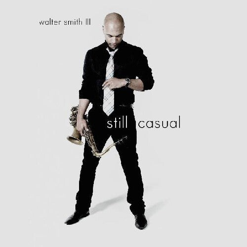 A vinyl record cover featuring a black and white image of a man with a saxophone, along with the title 'Still Casual' by Walter Smith III.