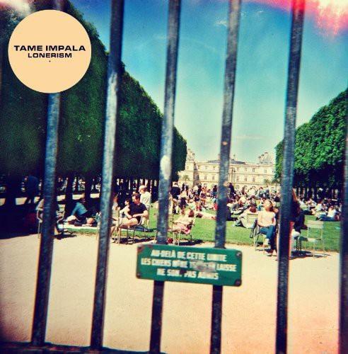 Album cover of Tame Impala - Lonerism with a photo of a park taken through a fence, including people and trees in the background.