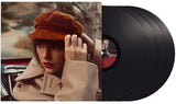 A set of eight black vinyl records labeled with 'Swift, Taylor - Red, Taylor's Version'. Accompanied by an image of Taylor Swift wearing a red hat and coat, suggestive of the album cover.