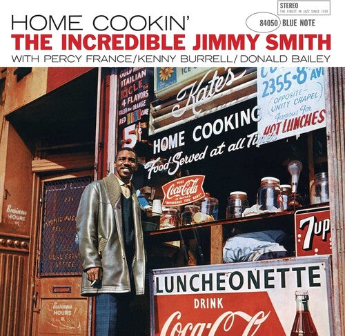 Album cover for 'Home Cookin'' by The Incredible Jimmy Smith with a man standing in front of a luncheonette.