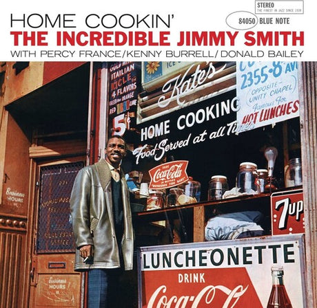 Album cover for 'Home Cookin'' by The Incredible Jimmy Smith with a man standing in front of a luncheonette.