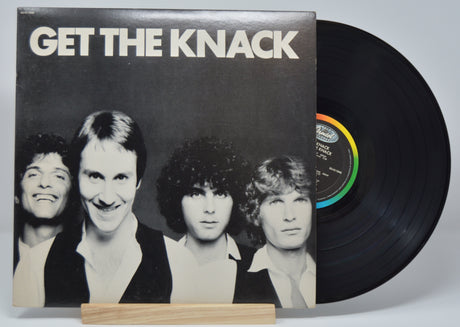 A vinyl record titled 'GET THE KNACK' by The Knack, with a black label and multicolored record.