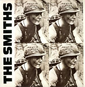 A vinyl record cover featuring a black and white image of a person with a meat is murder sign on their helmet, with the band name 'The Smiths' written above.
