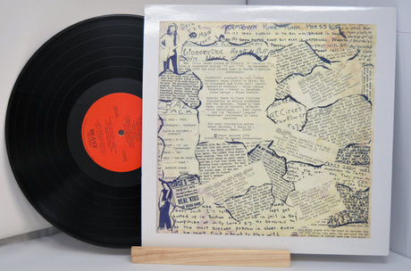 Vinyl record and back cover of the various artist compilation record from Worcester, MA titled 'Wormtown '78' showing a lot of typed and handwritten text.