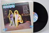 Vinyl record of the Miami Vice soundtrack featuring images of the main characters with a cityscape background.