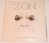Front vinyl record cover for 'Astral Projector' by Zon showing a drawing of a creepy face with crazy eyes and text of the band name and record title on a  white background.